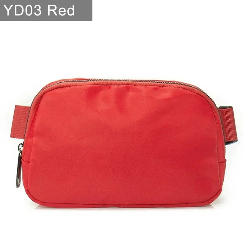 Red waterproof crossbody bag with suede trim and zip closure for running and yoga.