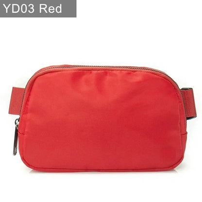 Red waterproof crossbody bag with suede trim and zip closure for running and yoga.