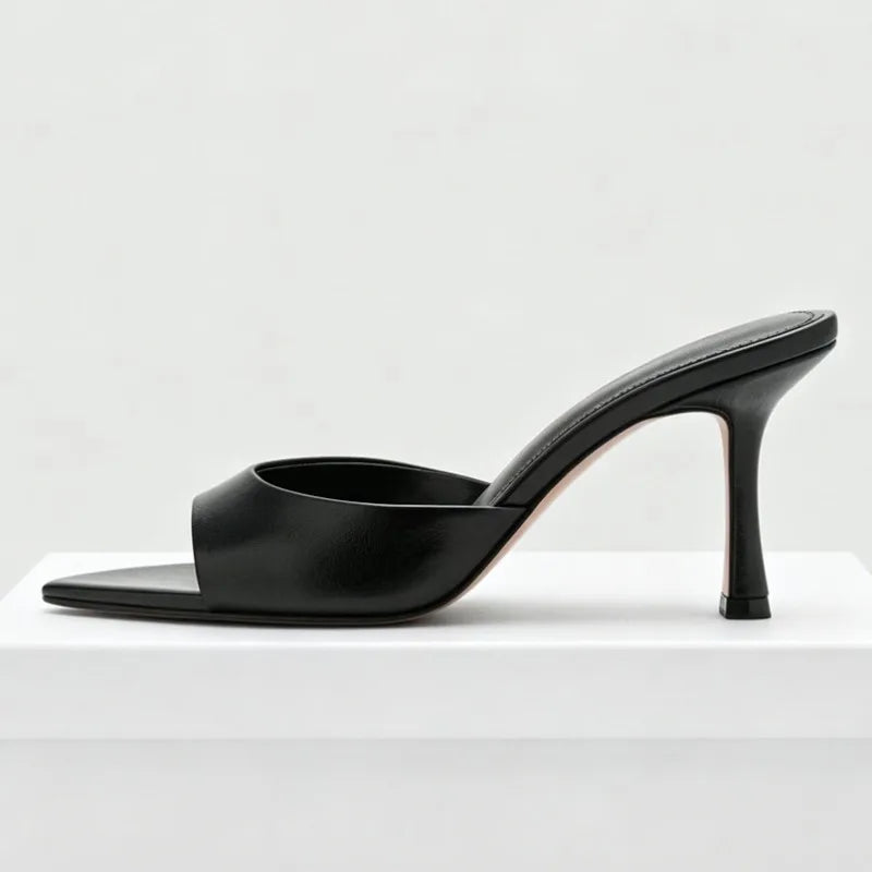 Black leather open-toe slip-on sandals with a thin stiletto heel for evening party wear.