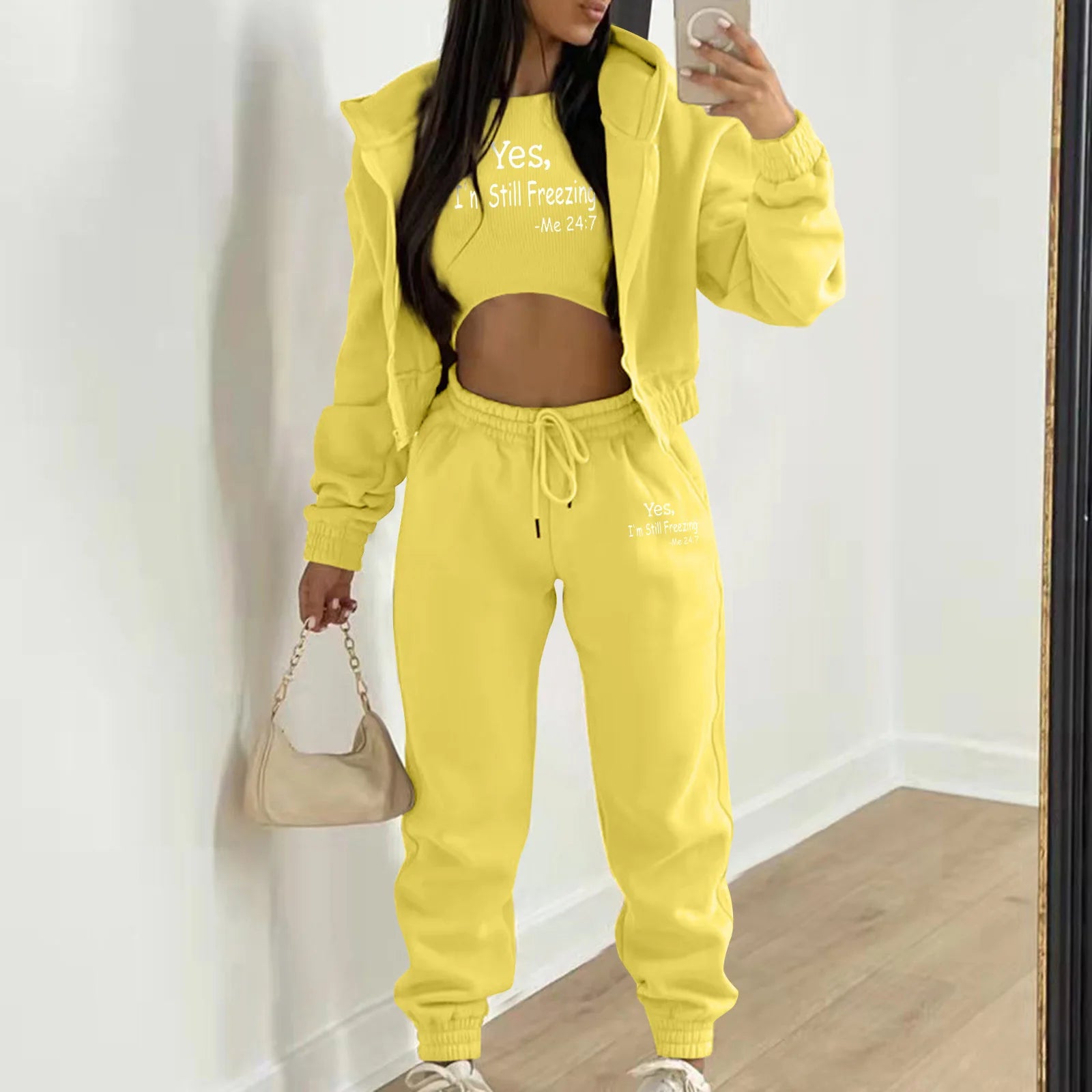 Bright yellow knit sweater set with white letter print, cropped top, and high waist joggers for lounging.