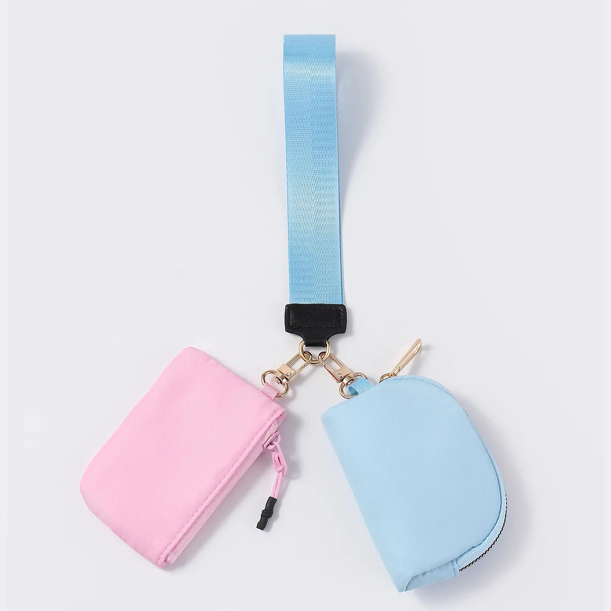 Pink and blue nylon dual zip closure wristlet for holding keys and coins on the go.