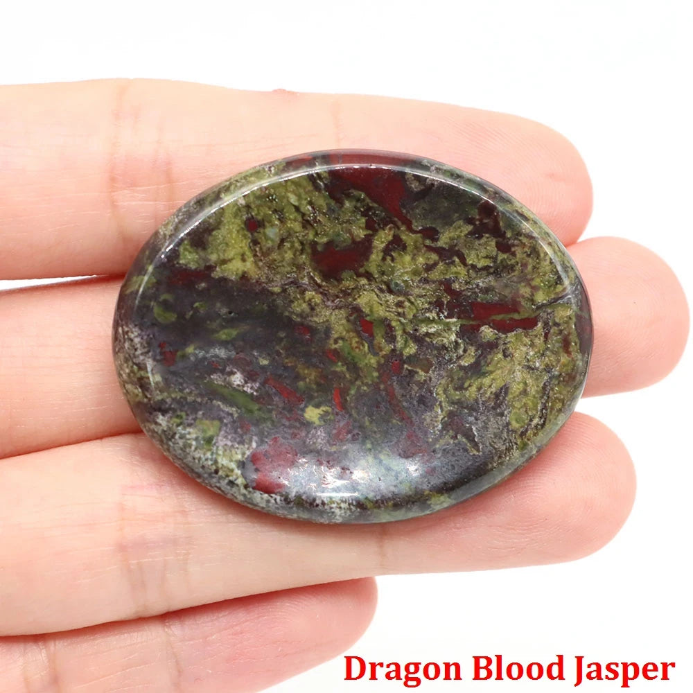 Polished oval dragon blood jasper palm stone with green and red mineral patterns, home decor for calming meditation.