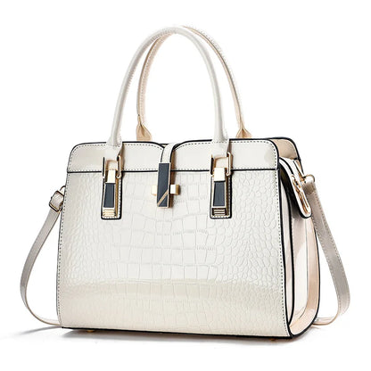 Off-white patent leather crocodile-pattern tote bag with dual handles, gold hardware, and a removable shoulder strap.