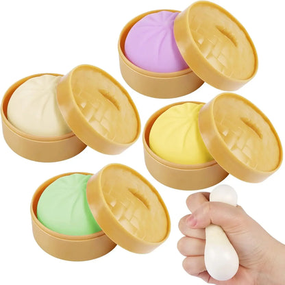 Colorful silicone dumplings in textured bamboo-style steamers, a squeezeable squishy fidget toy for sensory relief.