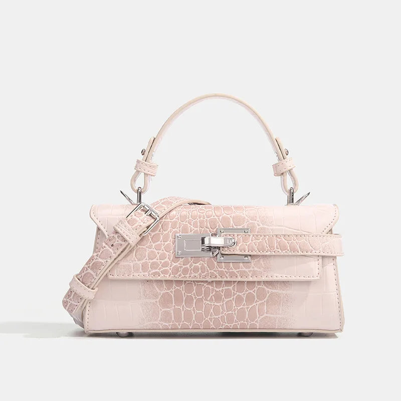 Blush pink faux leather structured crossbody bag with silver clasp and adjustable strap for everyday errands.