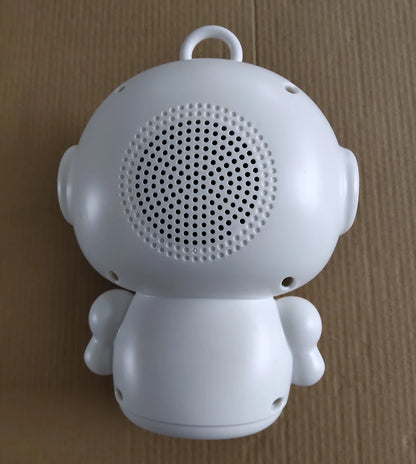 Back view of a white plastic education robot toy featuring a circular speaker grille, for interactive language learning.