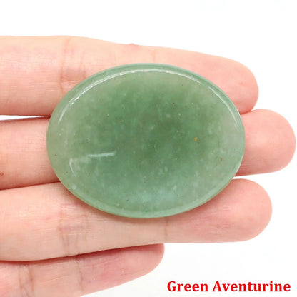 Polished green aventurine palm stone held in hand for meditation home decor.