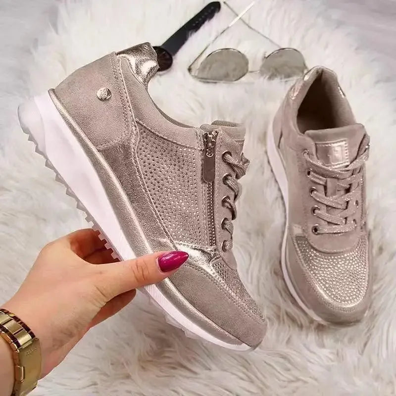 Taupe wedge sneakers with metallic accents, side zipper, and breathable details for comfortable casual wear.