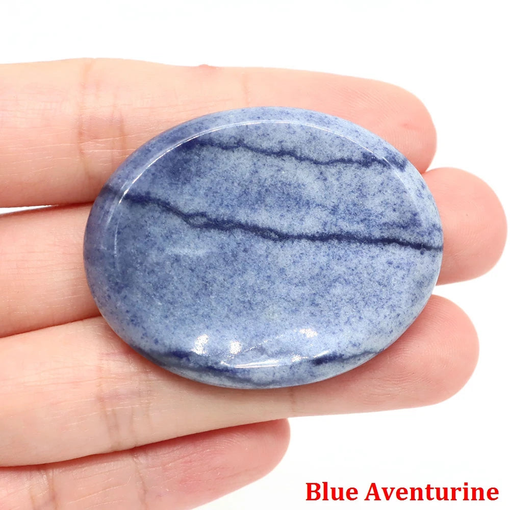 Smooth, oval blue aventurine home decor palm stone with natural dark vein details for meditation.