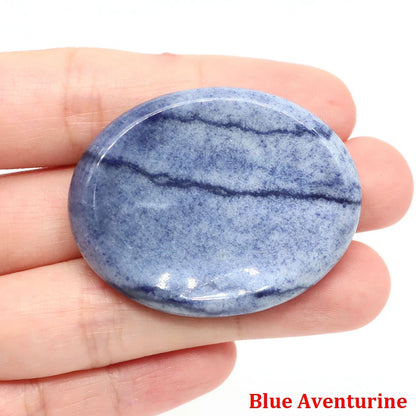 Smooth, oval blue aventurine home decor palm stone with natural dark vein details for meditation.