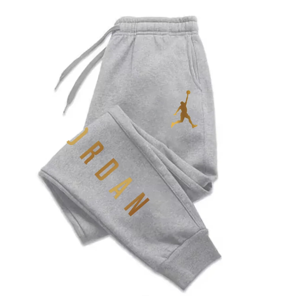Grey midweight joggers with gold letter print and drawstring waist, fitted for casual workout wear.
