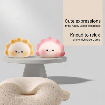 Yellow and pink dumpling steamed bun squishy fidget toy for a portable squeeze toy to relieve stress.
