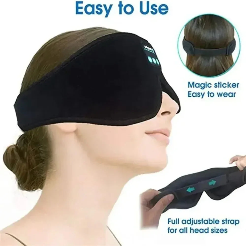 Black fleece Bluetooth sleep mask with integrated control buttons, worn by a person, featuring an adjustable strap.