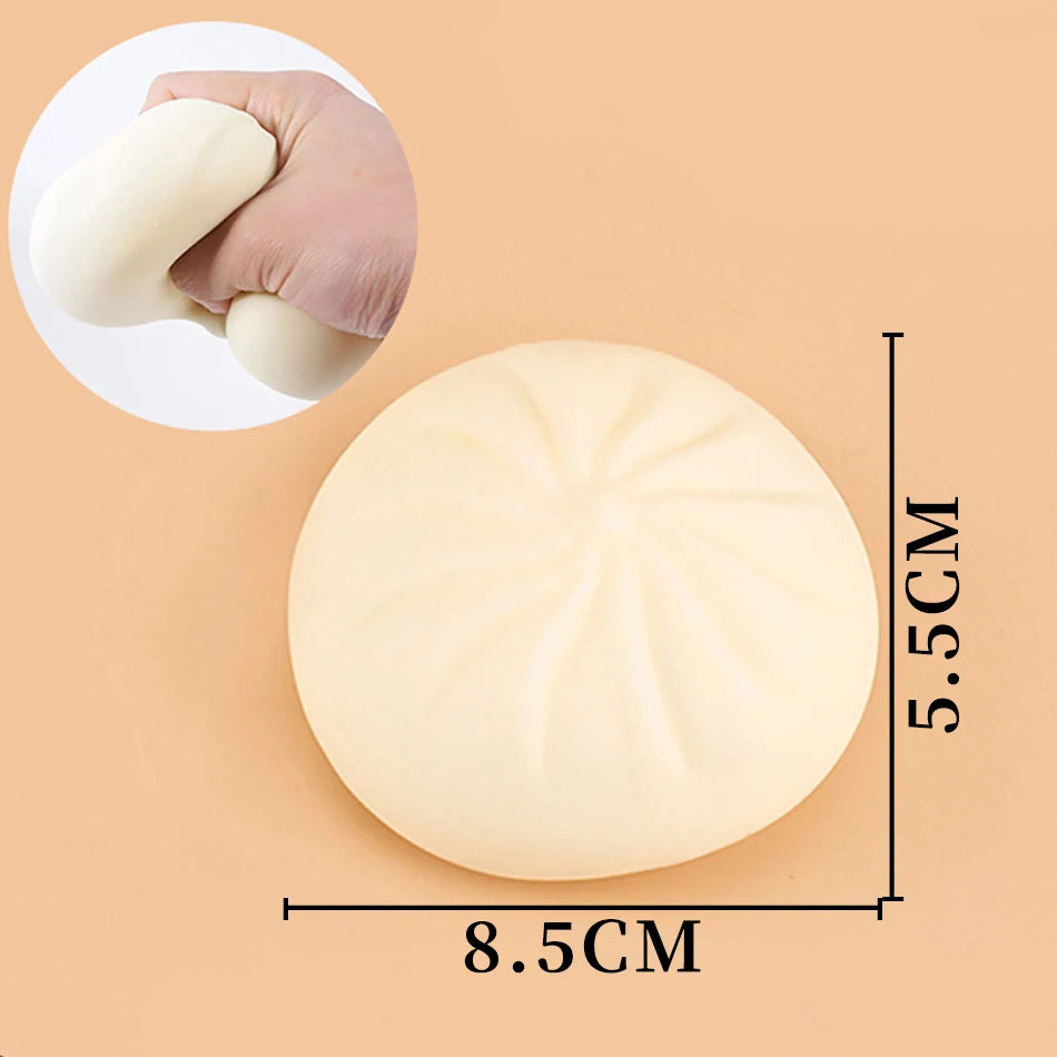 Off-white silicone dumpling squishy fidget toy with pleated texture for tactile sensory relief.