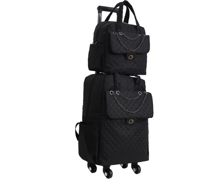 Black quilted nylon rolling luggage set with chain accents on front flap pockets and matching handbag.