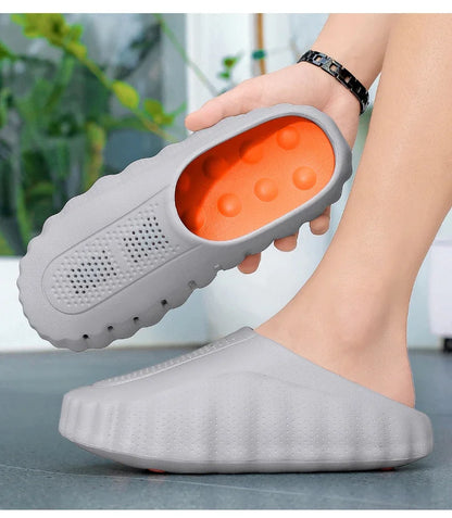 Grey rubber slip-on sandals with cushioned orange interior and thick platform sole for all-day wear.