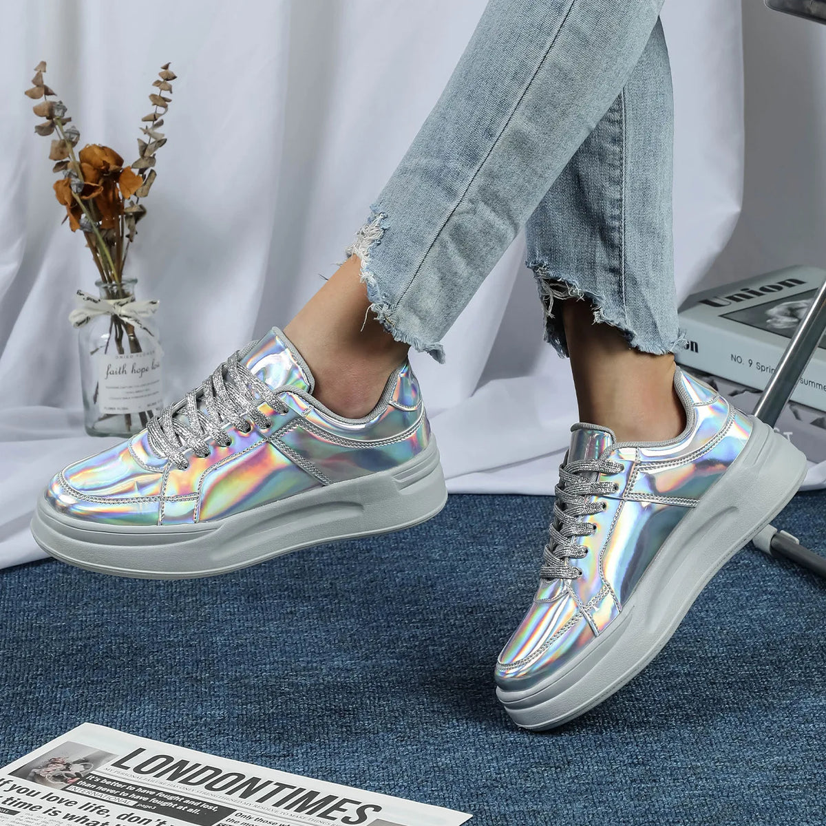 Silver holographic metallic casual sneakers with thick grey soles and sparkly laces.