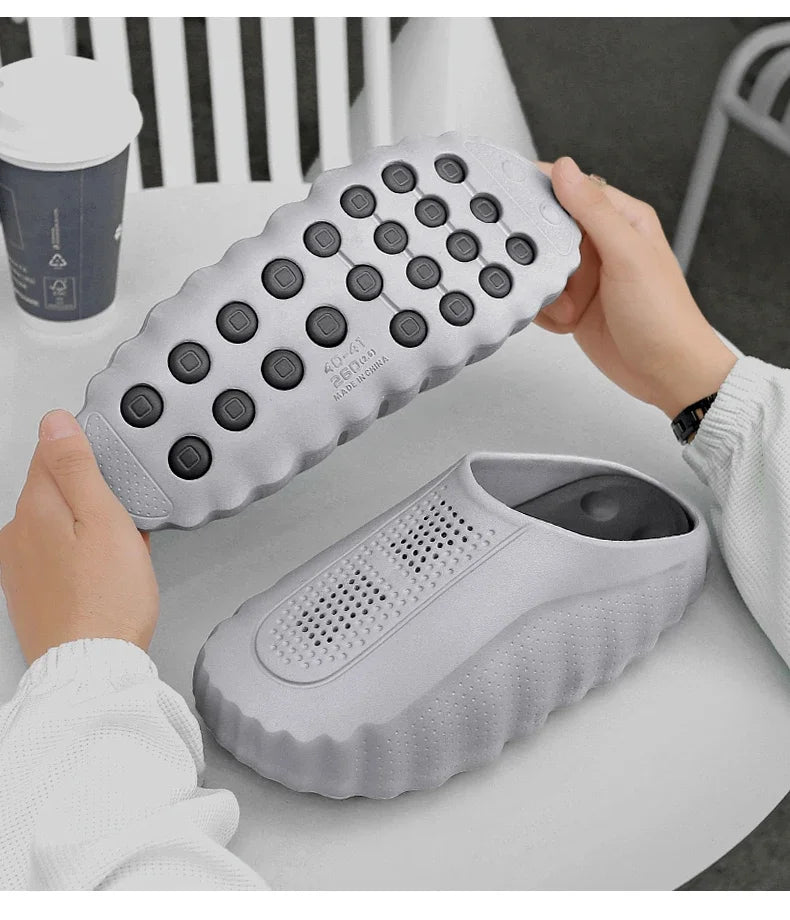 Grey slip-on sandals with a cushioned thick sole and non-slip tread for daily wear.