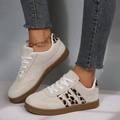 Beige suede sneakers with leopard print stripes and white laces, featuring cushioned insoles for outdoor walking.