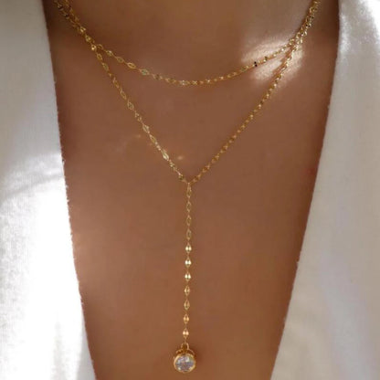 Layered crystal pendant necklace featuring double chains and rhinestone accents