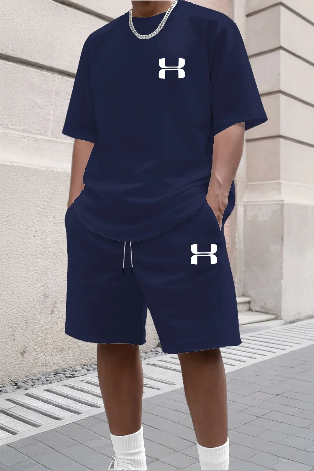Navy blue knit set with white logo, short sleeve tee and drawstring shorts for relaxed athletic wear.