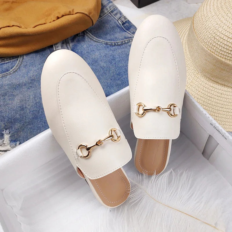 White slip-on sandals with gold chain detail for all day wear.
