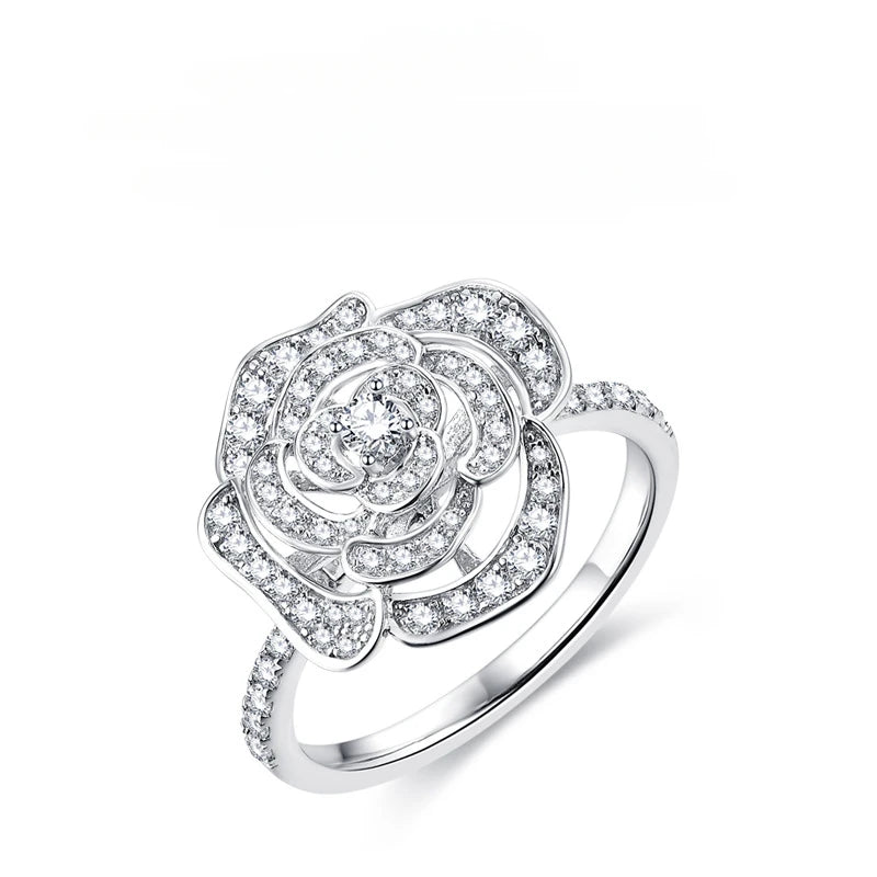 Silver flower ring with a paved camellia design set with small moissanite crystals.