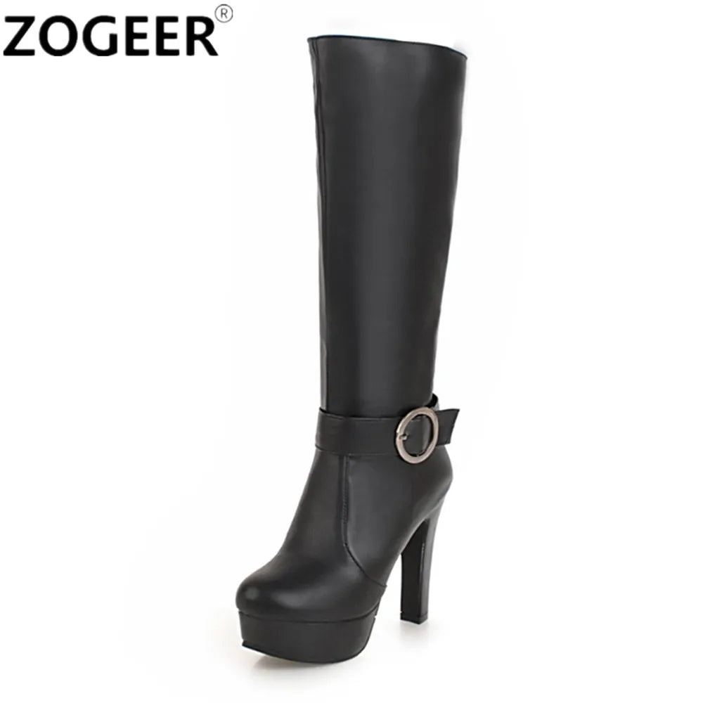 Black knee-high platform boot in smooth faux leather featuring a chunky high heel and ankle strap with round metal buckle.