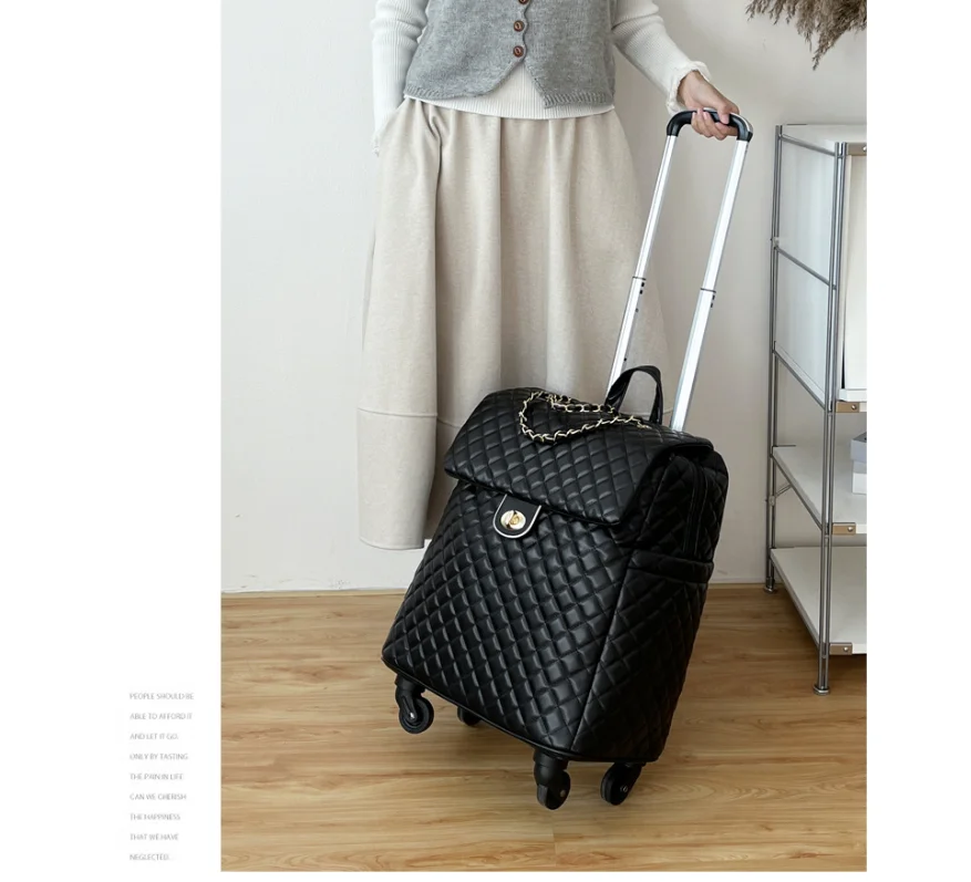 Black quilted faux-leather rolling luggage with a retractable handle, front flap, and gold chain detail.