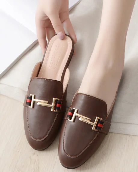 Brown faux leather closed toe slip-on mules featuring gold metal chain detail for everyday outdoor wear.