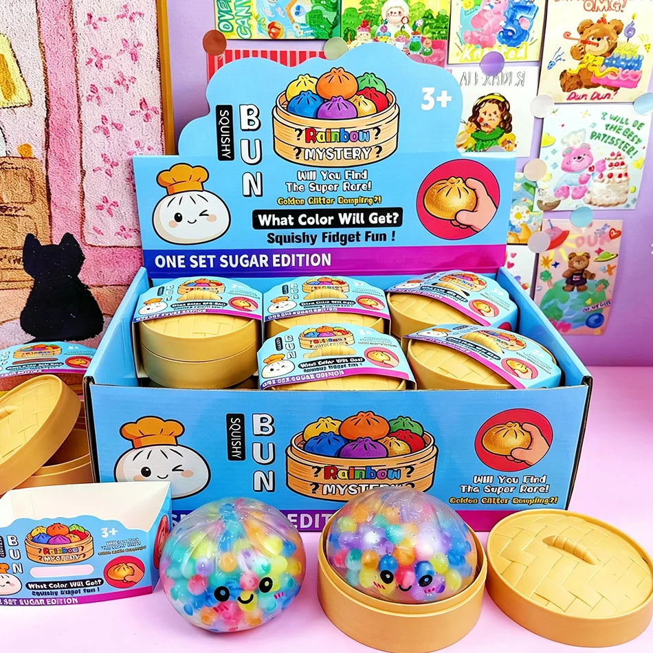 Multi-colored, soft foam dumpling steamed bun slow rising squishy fidget toy in a yellow plastic steamer basket.