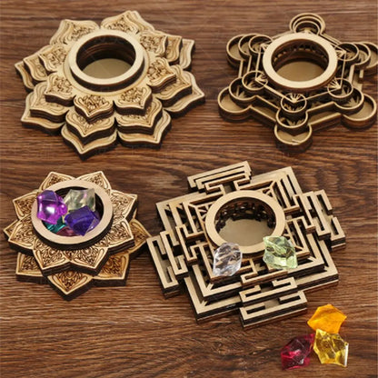 Four light brown wooden crystal stands with intricate sacred geometry and lotus patterns on a wood surface.