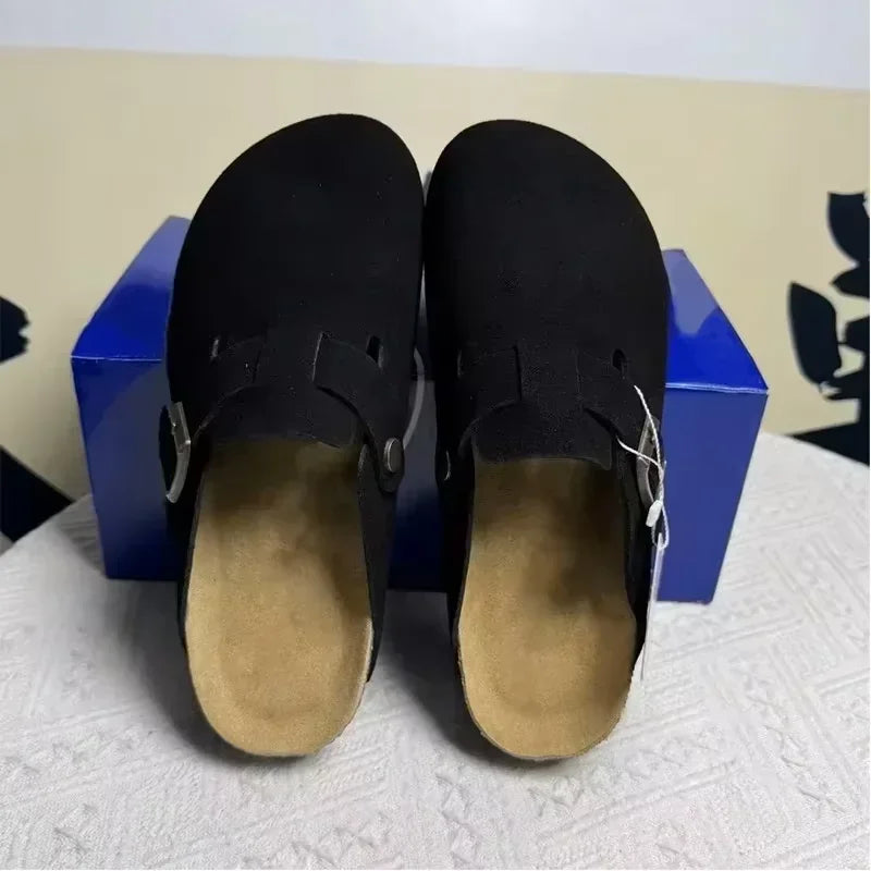 Black rubber mules with adjustable silver buckles and tan insoles, these non-slip beach shoes offer casual comfort.