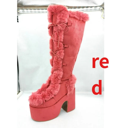 Red suede platform boot with high block heel, faux fur trim, and lace-up front.