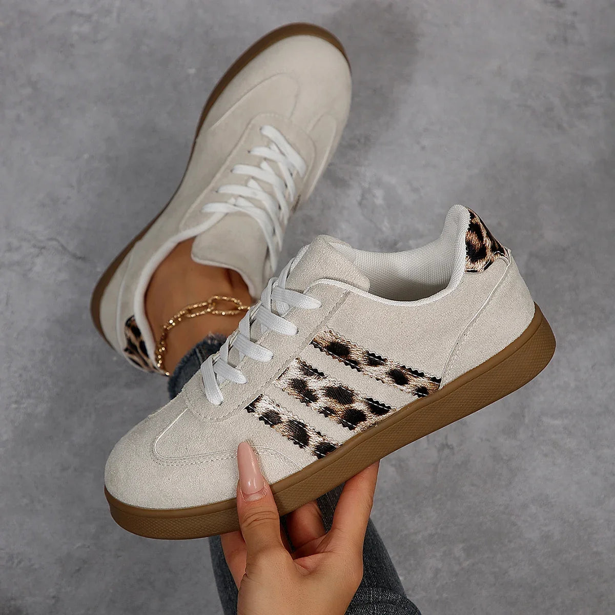 Beige suede sneakers with leopard print stripes and cushioned insoles for daily walking.