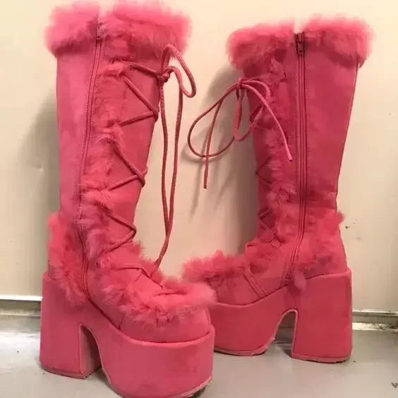 Hot pink faux fur platform wedge snow boots with laces, side zippers, and mid-calf height.