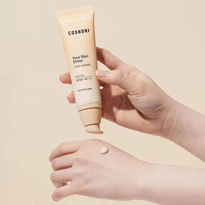 Tone up cream brightening makeup base dispensed from a pump tube onto a hand