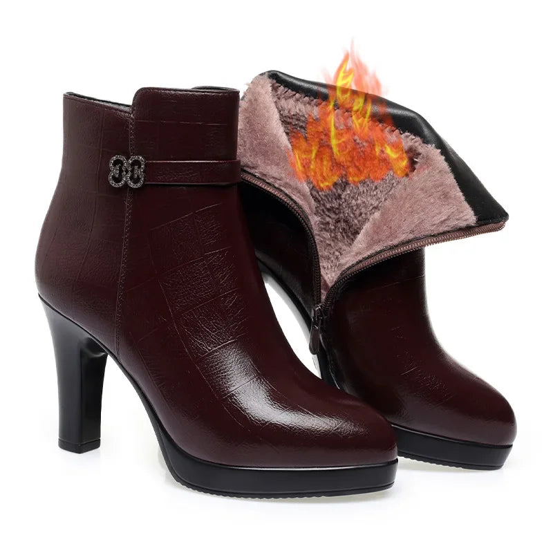 Dark maroon leather ankle boots with high block heels, platform soles, decorative ankle straps, and furry interior lining.