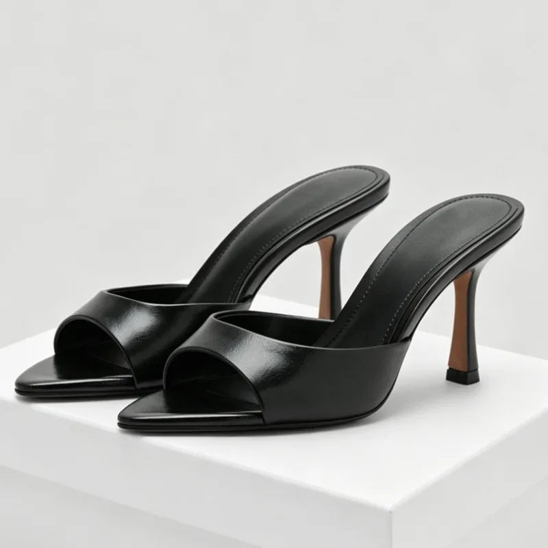 Black leather open-toe slip-on heels with a thin stiletto for parties.