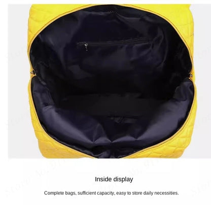 Open yellow PU leather travel suitcase with dark fabric interior lining and a zippered pocket.