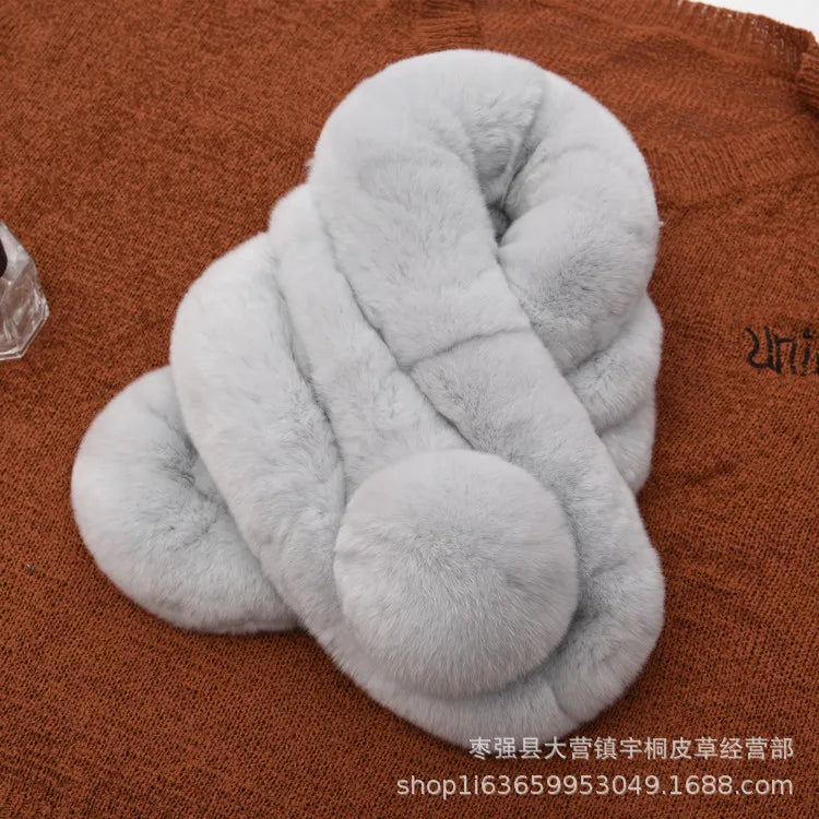 Light gray rabbit fur scarf with a triple-tube design and pom pom detail.