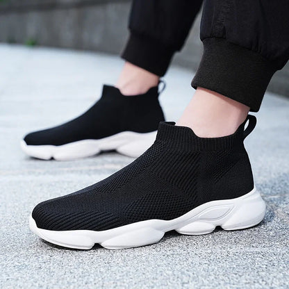 Black breathable knit slip-on sneaker with a white cushioned sole for casual daily walking.
