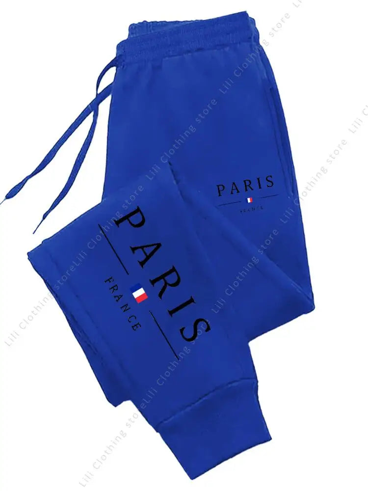 Royal blue fleece jogger pants with Paris France print and drawstring for comfortable lounge wear.