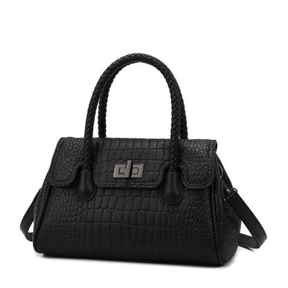 Black faux leather structured crossbody with a braided handle and turn-lock closure for everyday use.