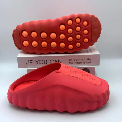 Red EVA sandals with cushioned massage soles for outdoor wear.