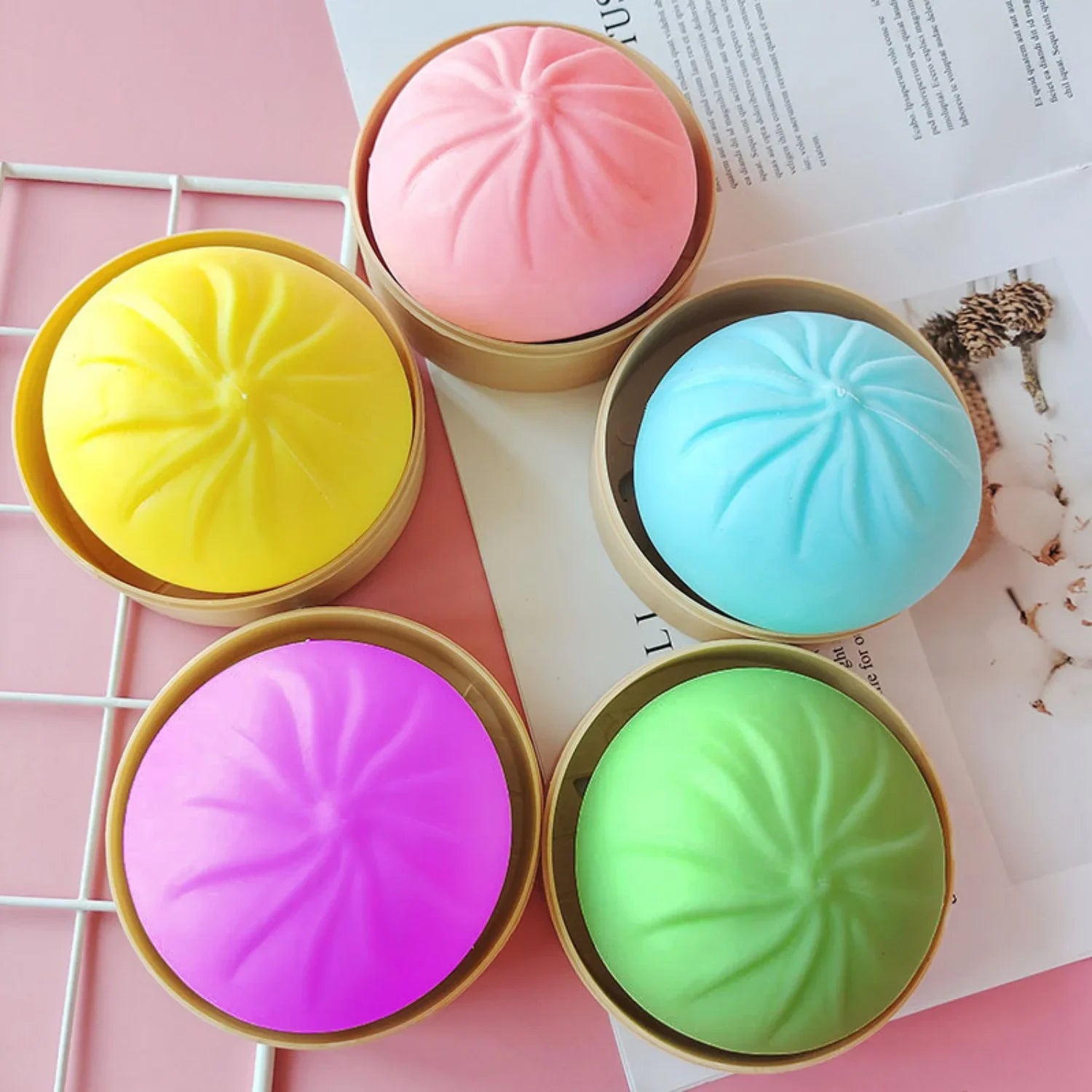 Colorful silicone bun fidget toys in mini bamboo steamers for stress relief and sensory play.