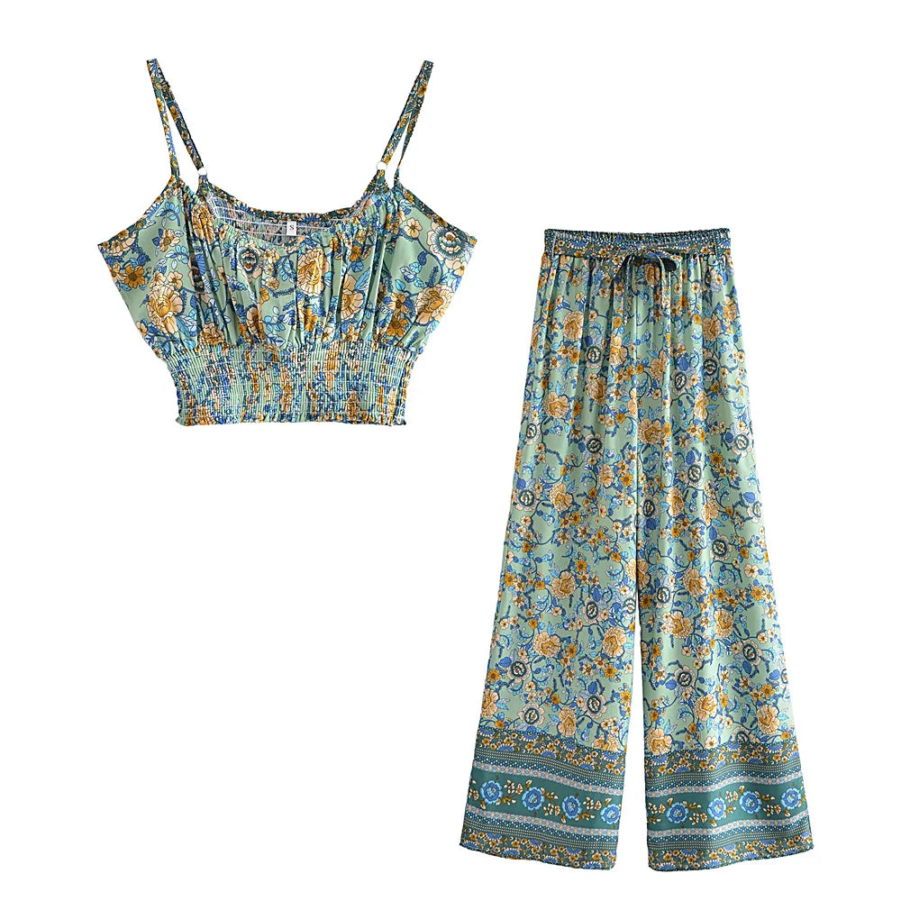 Green floral flowy two-piece set with a smocked crop top and wide leg drawstring pants for casual summer wear.