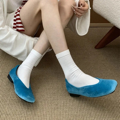 Blue suede square toe slip-on flats with cushioned soles for comfortable daily wear.