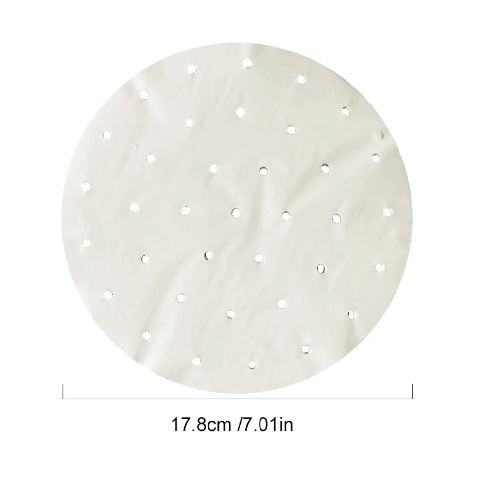 Round white parchment paper steamer liner, 17.8 cm diameter, with pre-punched ventilation holes.