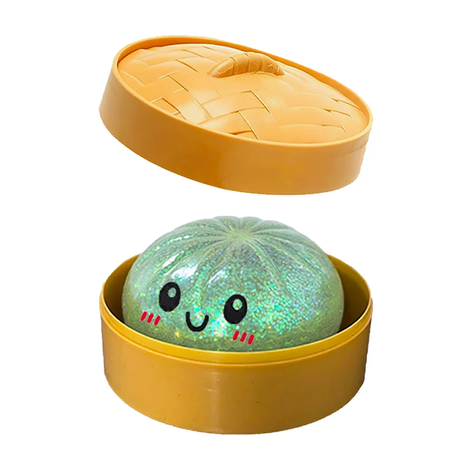 Green glittery squishy fidget toy with a smiling face inside a yellow plastic mini steamer for sensory play.